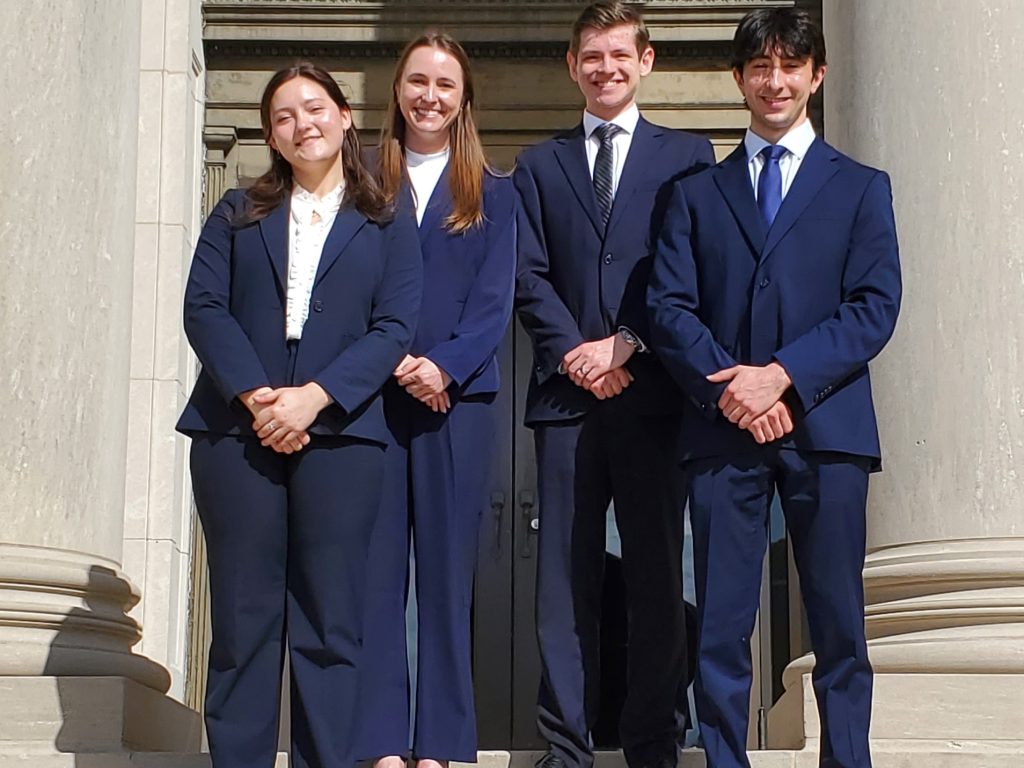 Photo of four Campbell Law advocates posing in front of courthouse in Baton Rouge at Bayou Challenge