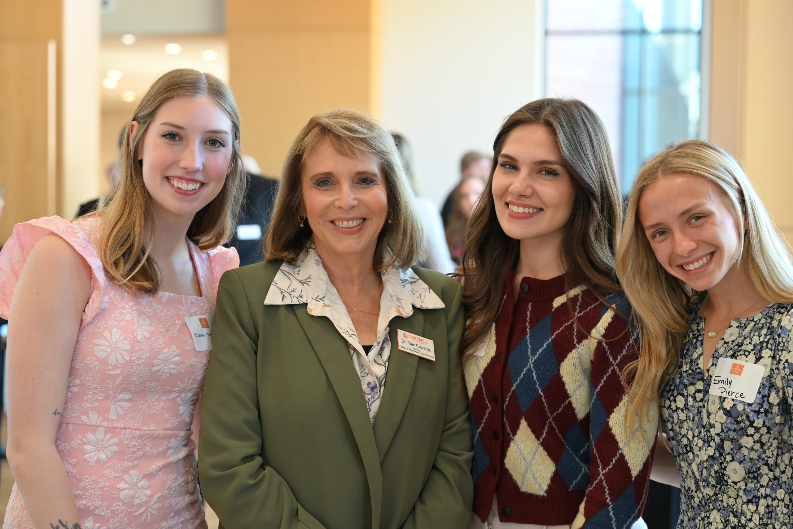 Nursing director with three nursing scholarship recipients