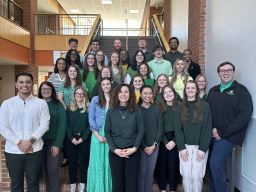 2026 chapter inductees standing on the staircase of Maddox Hall with faculty advisor, Dr. Beth Mills