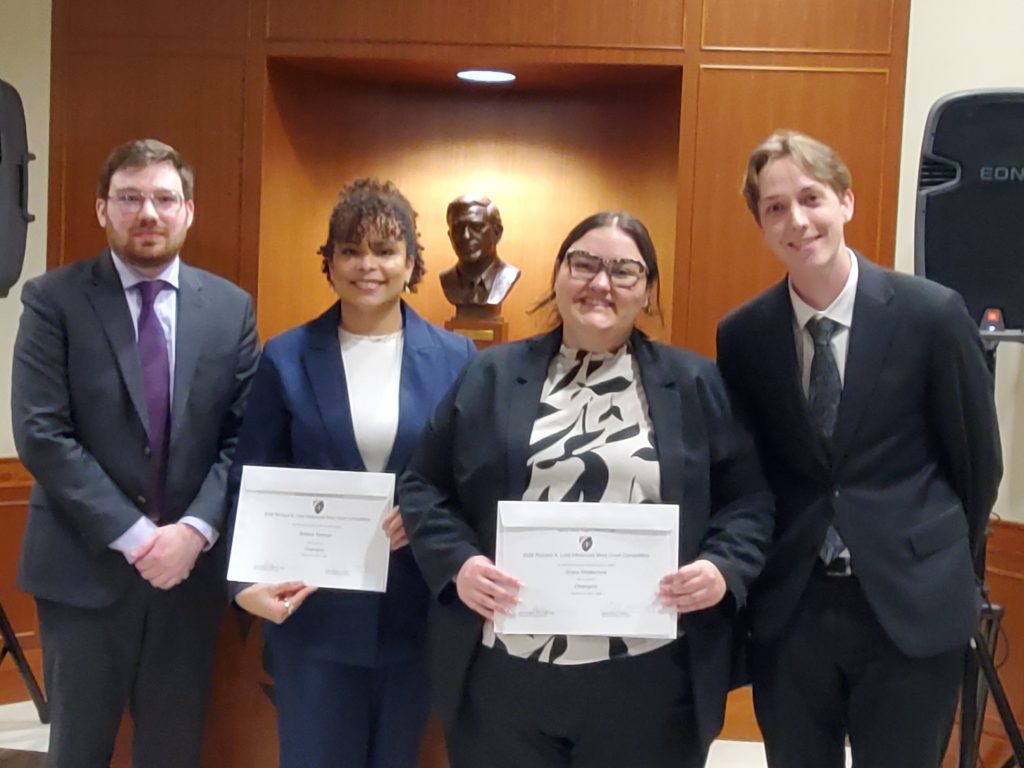 Photo of four people including Brittany Swanger and Grace Whittemore, 2026 Champions