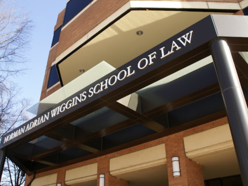 Photo of the outside of front of law school with sign that reads Norman Adrian Wiggins School of Law