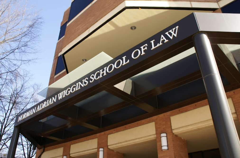 Photo of the outside of front of law school with sign that reads Norman Adrian Wiggins School of Law