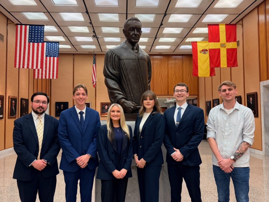 Photo of Campbell Law Estrella Mock Trial Competition 2026 championship winning advocates in Puerto Rico Robert Massey ‘26, Jessica Griffin ‘26, Hunter Walker ‘27 and Whitney Peck ‘27 and coaches alumni Jernigan Newell ‘23 and Christian Lunghi ‘23.