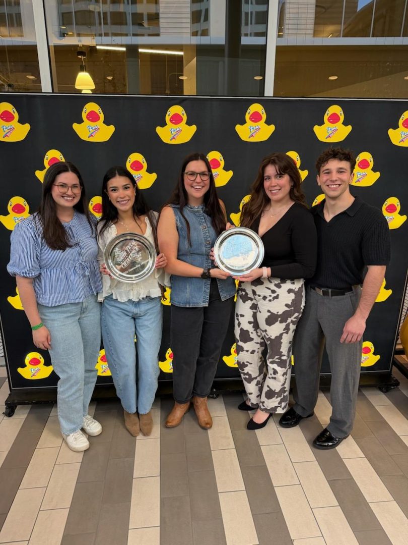 Photo of South Texas Campbell Law advocates and coach Sydney Kraft '25 holding awards