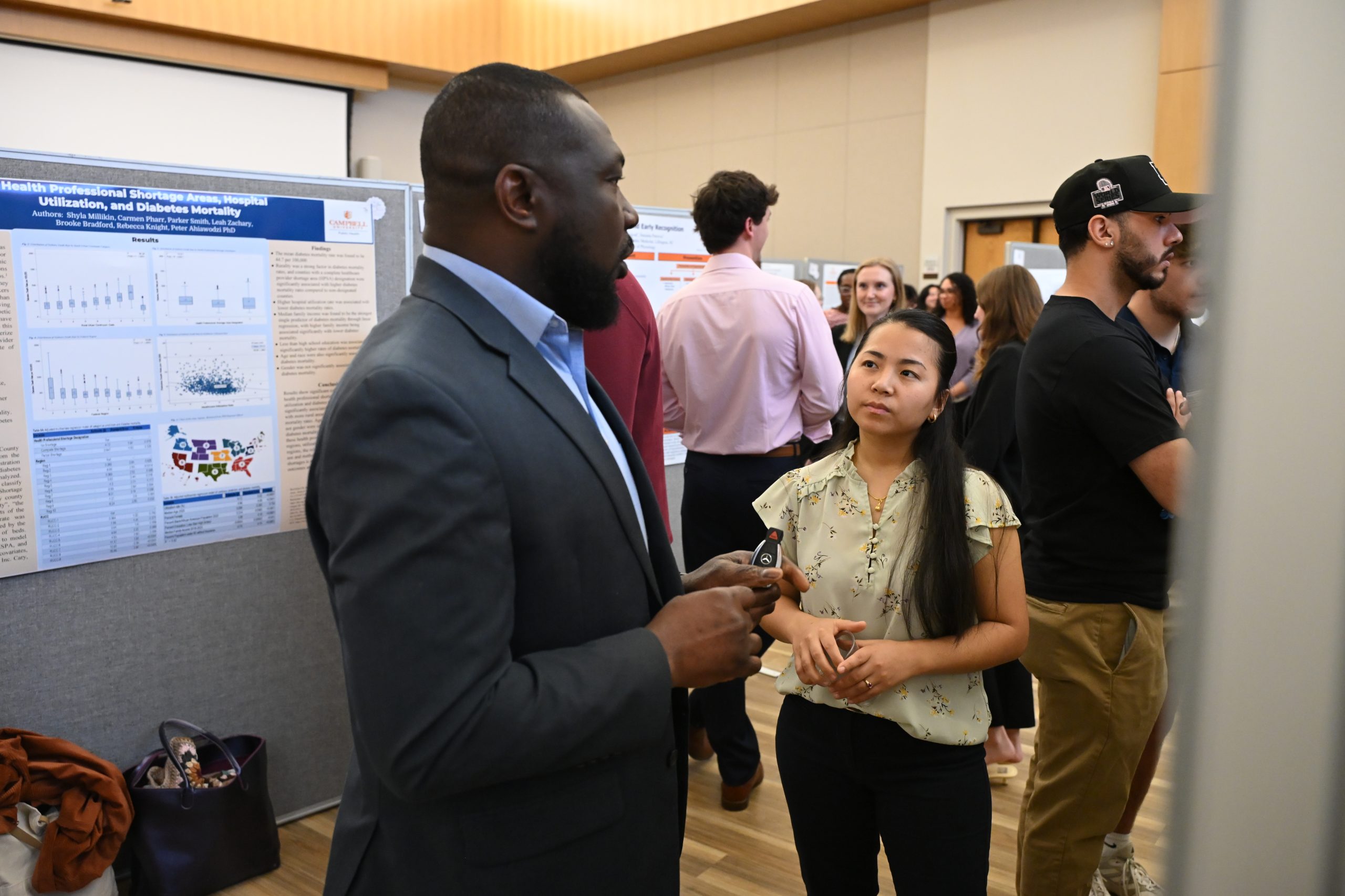 African male faculty member talking with female student