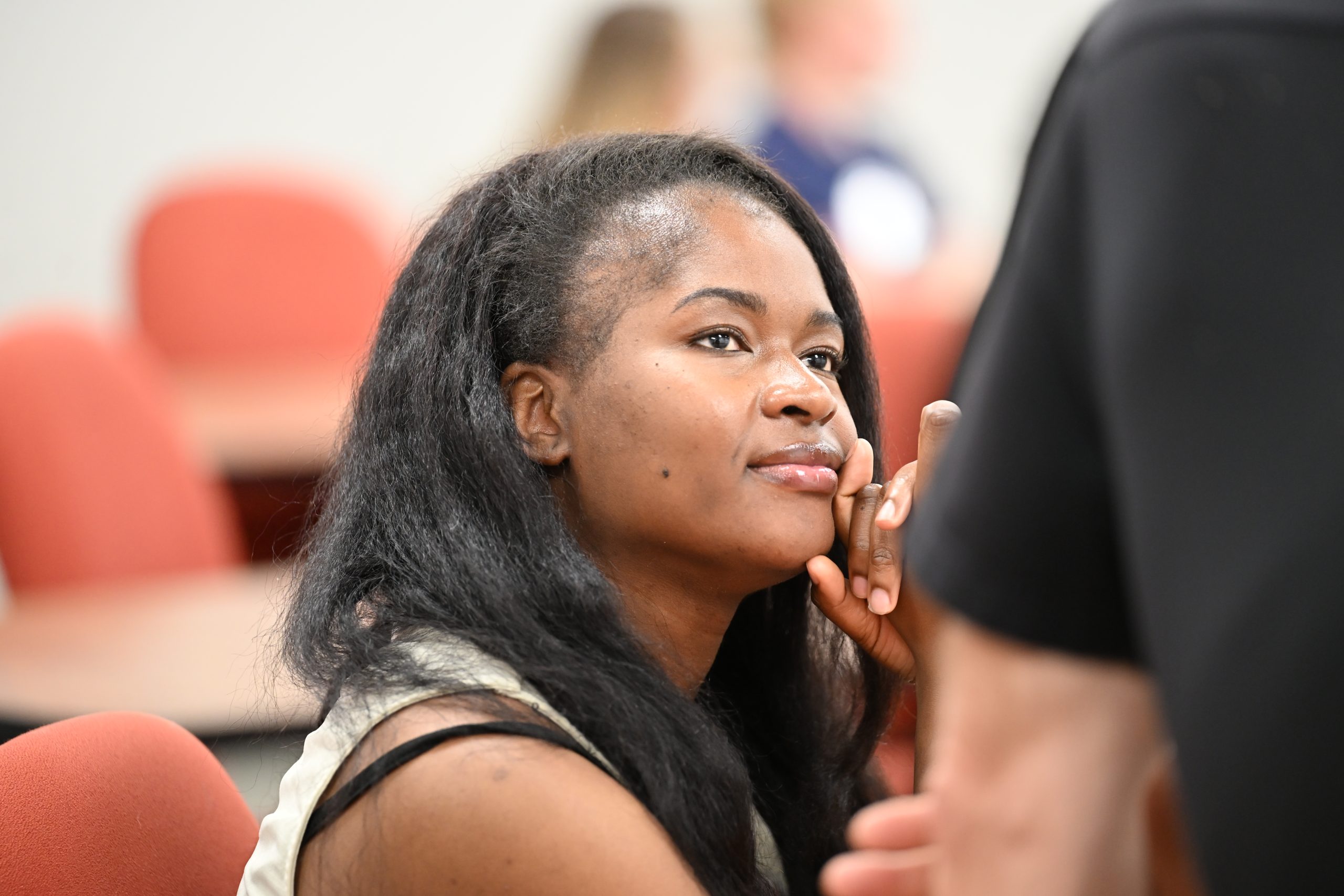 Prospective female student looking up at faculty member in conversation.