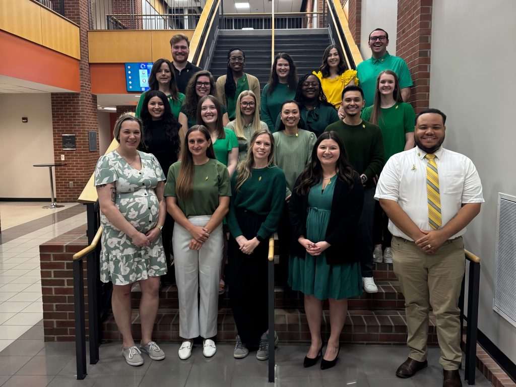 Alpha Zeta Chapter of Phi Lambda Sigma 2024-2025 group photo standing on stairs of lobby of maddox hall