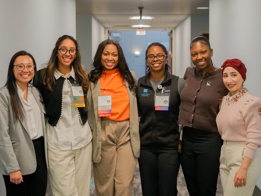 Group of six female students in business casual attire.