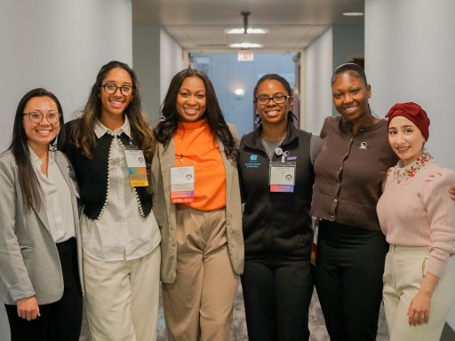 Group of six female students in business casual attire.