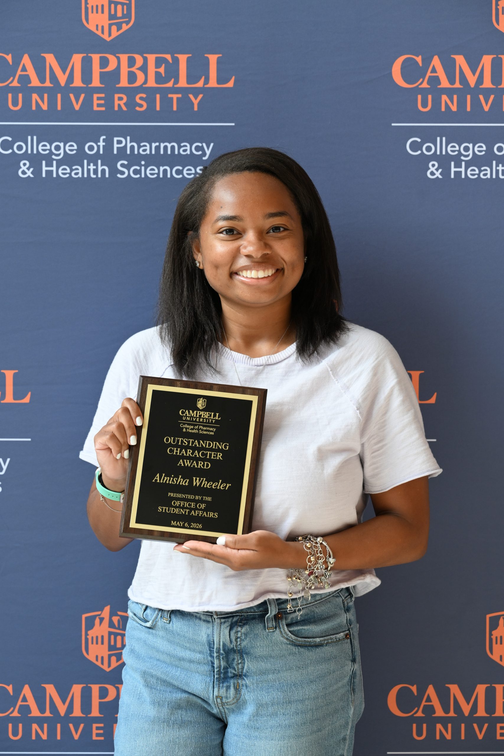 Female holding awards plaque.