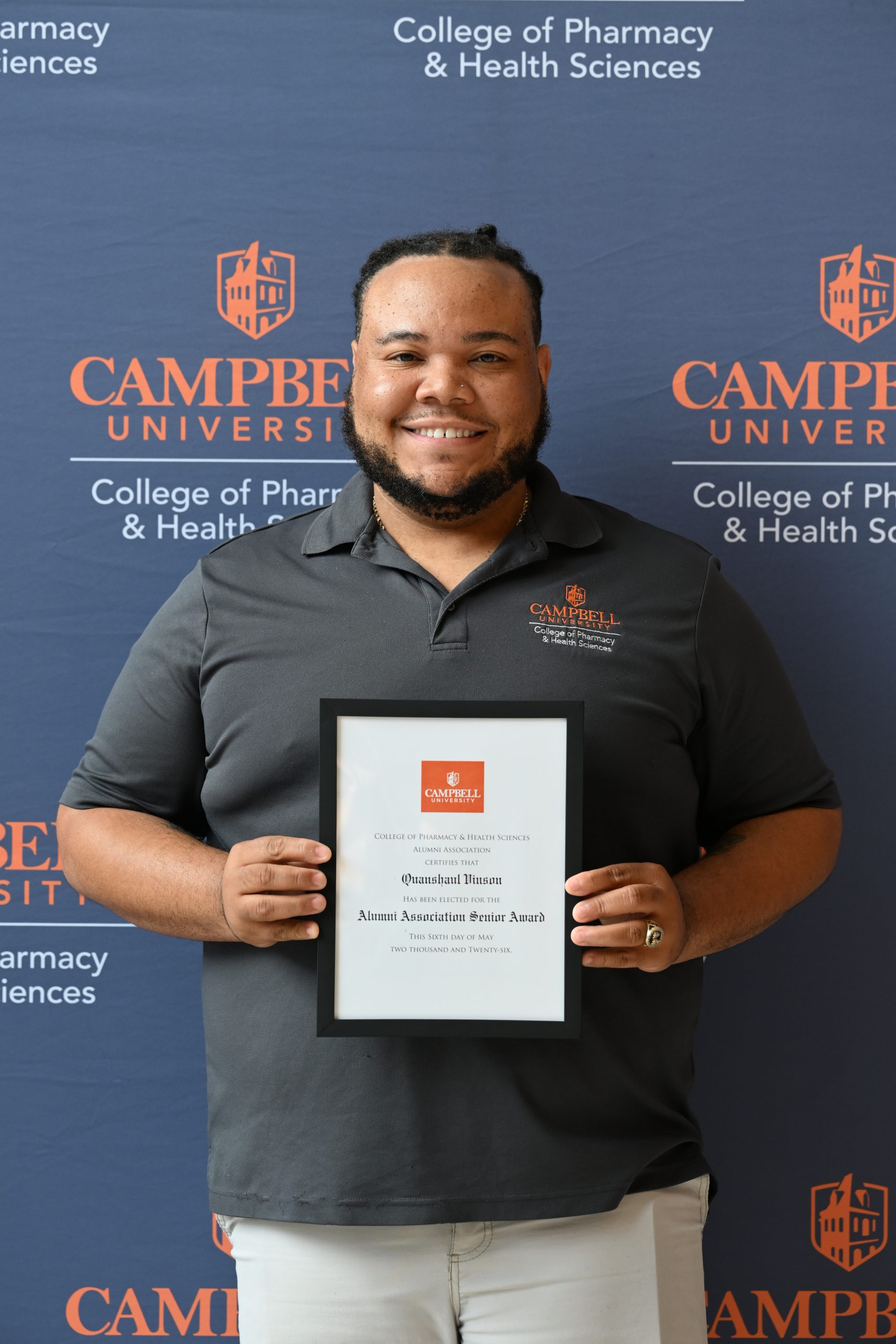 Male holding a certificate.