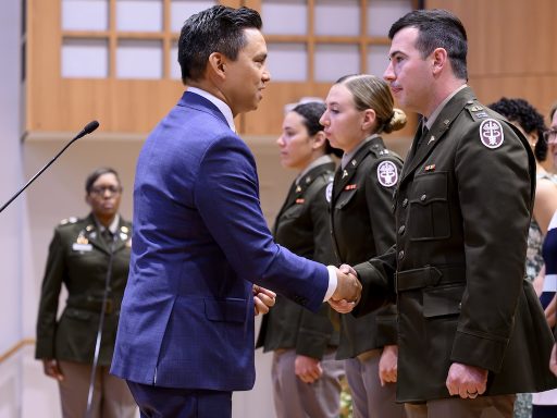 CUSOM Dean Dr. David Tolentino congratulates new Army lieutenant