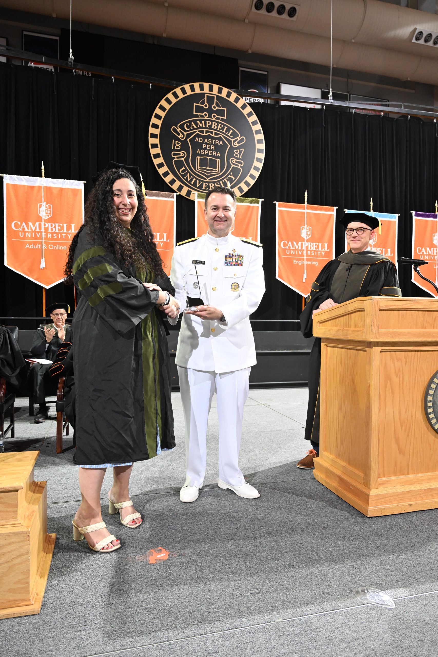 Dr. Eliana Wood hands award to Dr. Brandon Taylor