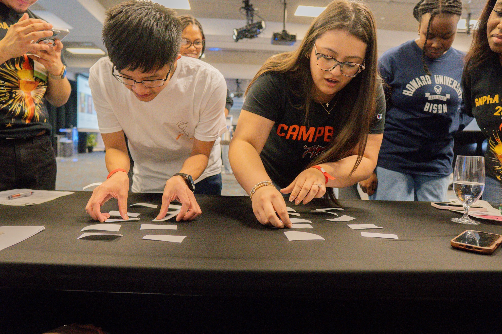 Male and female student playing a matching game on a table.
