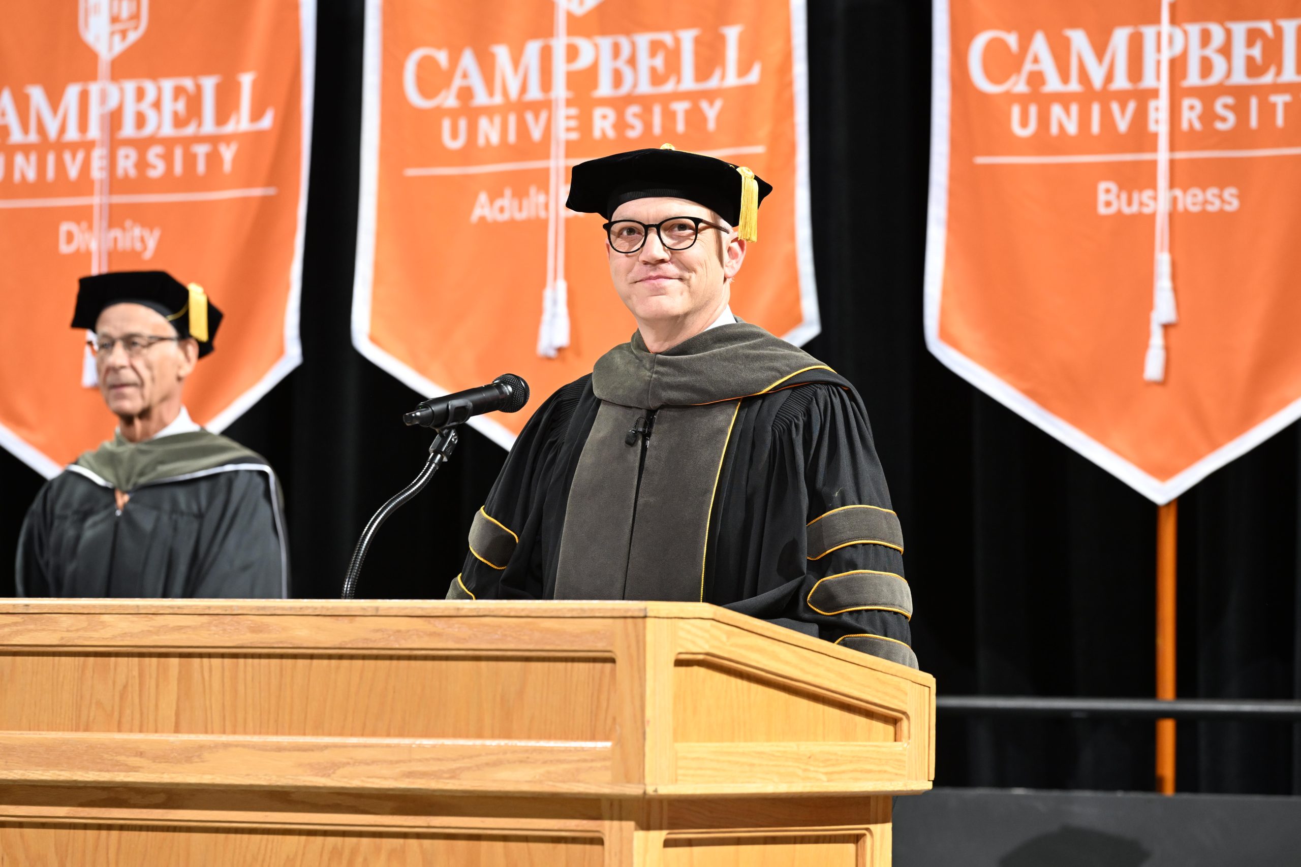 Male dean of CPHS smiles at podium