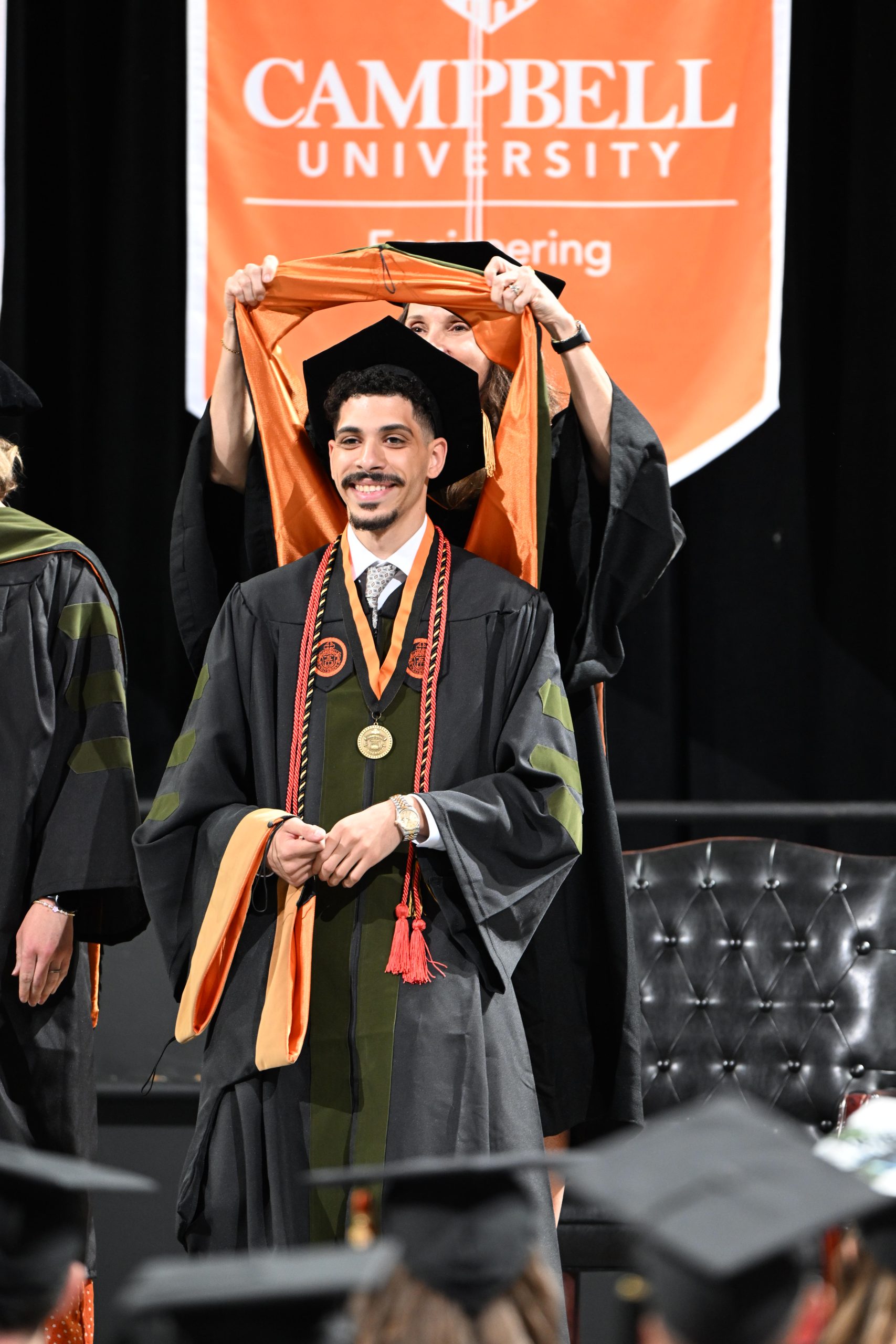 Male student being hooded