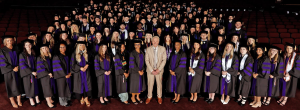 Photo of the Class of 2026 posing in the graduation gowns with Dean Leonard standing in the middle in the front