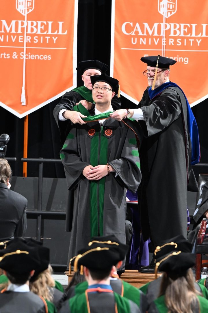Photo of hooding of CUSOM graduate