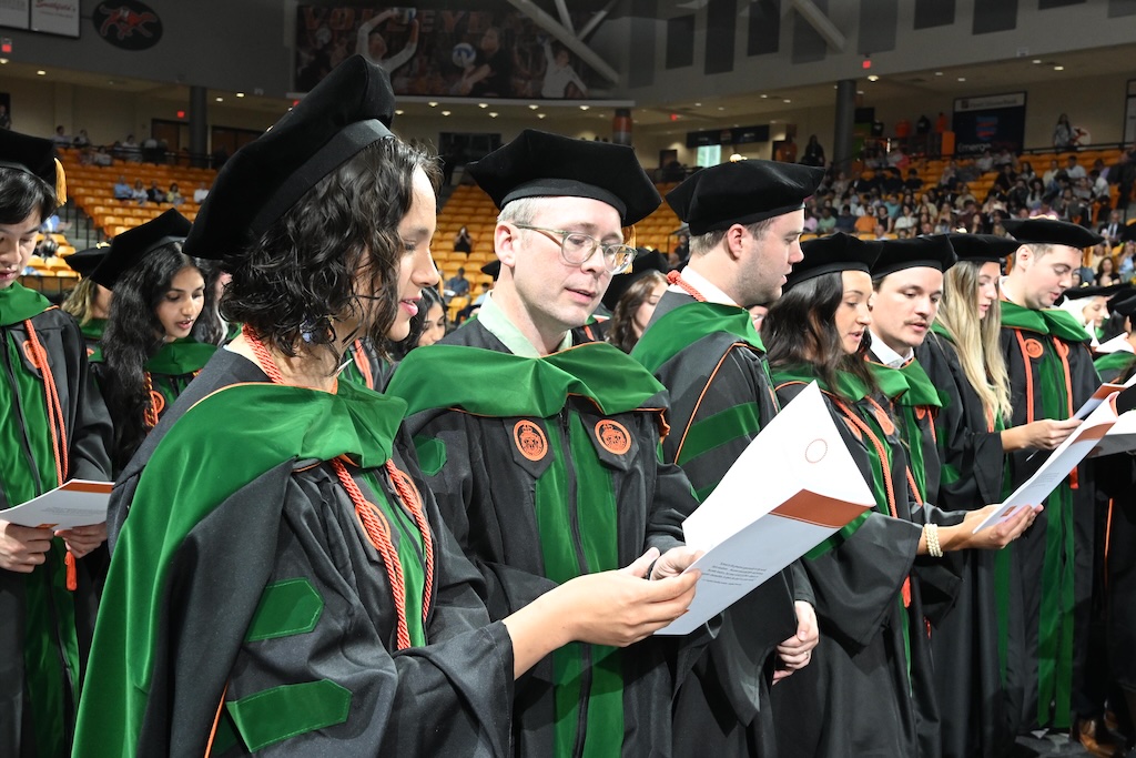 Photo of CUSOM grads singing alma mater