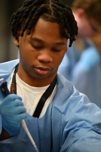 Male student holding pipette