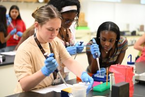 Two female students using pipettes