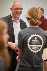 Male adult talking with student