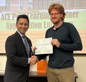 Dr. Tolentino poses with a student holding Peer Learning Partner award.