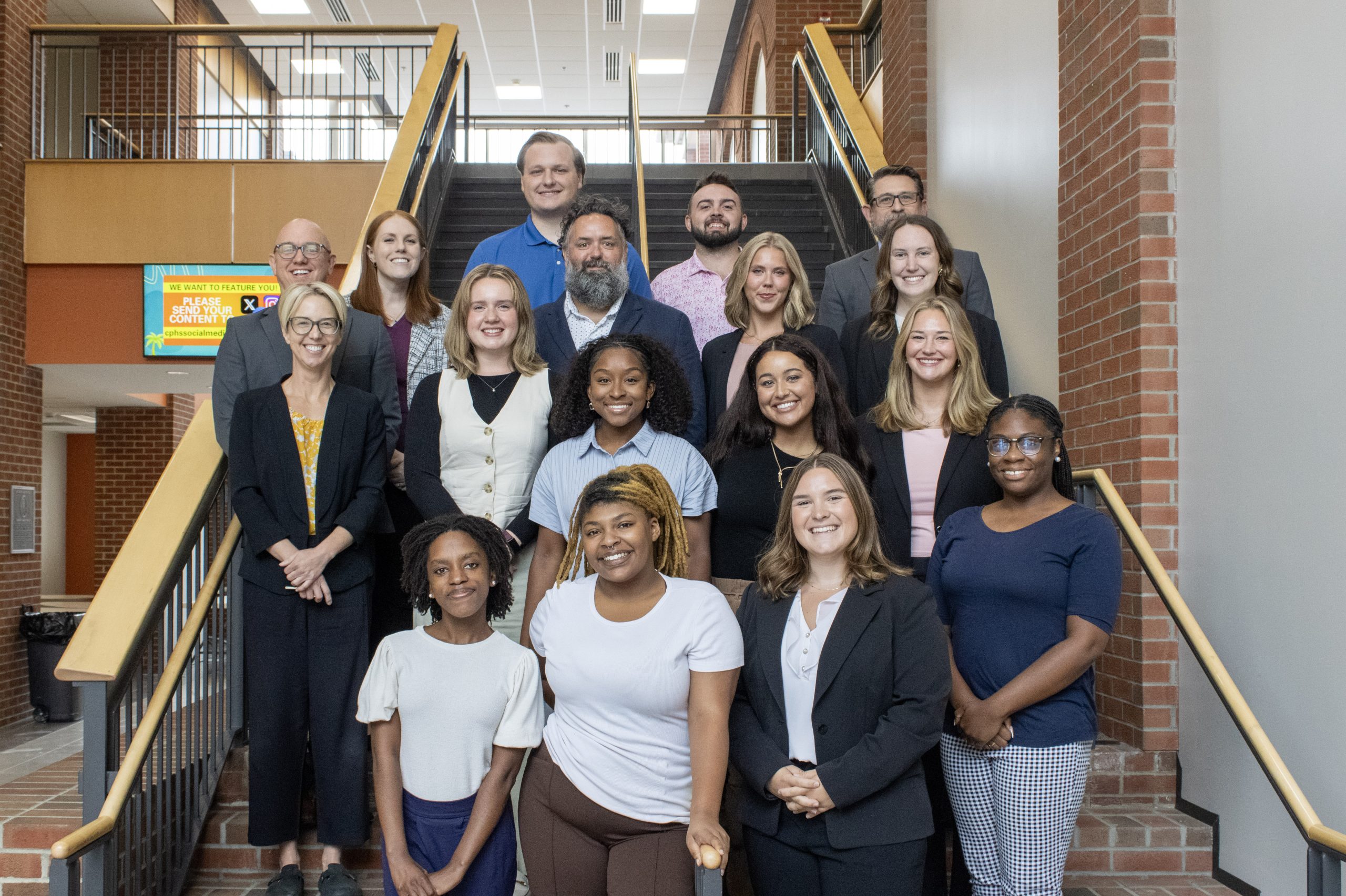 Students and faculty on staircase for photo
