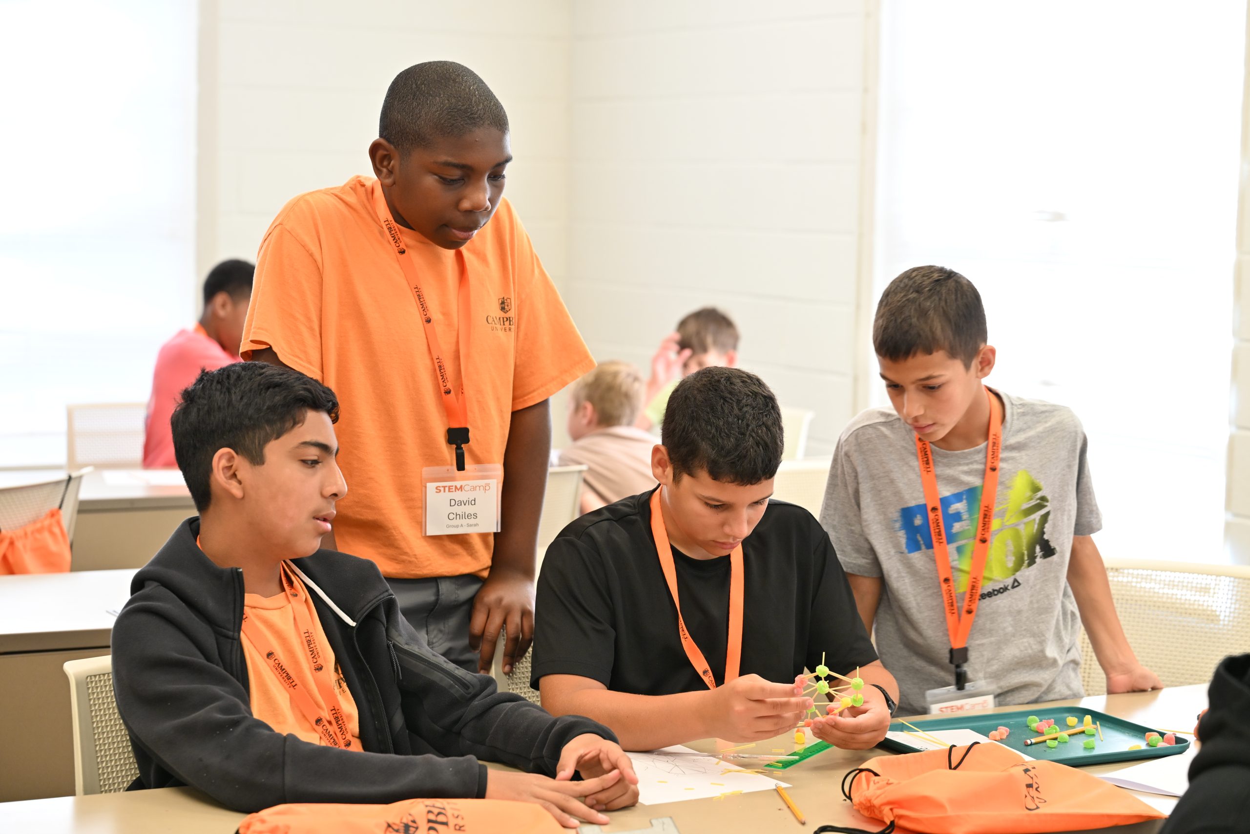 Middle school STEM Camp participants work together to build a chassis during a hands-on STEM activity at Campbell University.