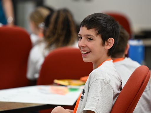 Middle school STEM Camp participant smiles while taking part in a classroom activity at Campbell University.