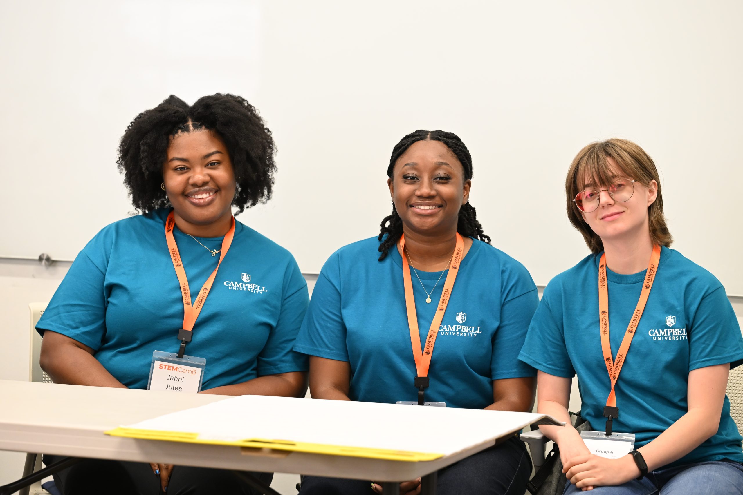 Three Campbell University student mentors pose together during the annual middle school STEM Camp.