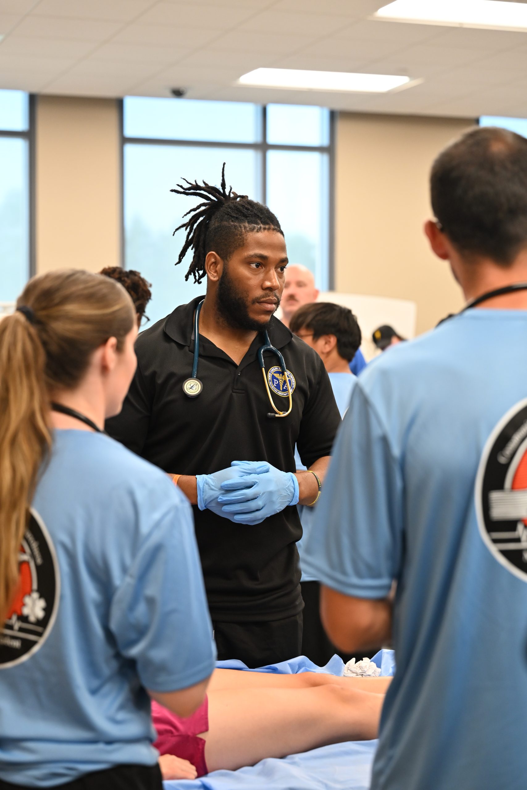 Male PA student listening to instruction in the simulated ER.