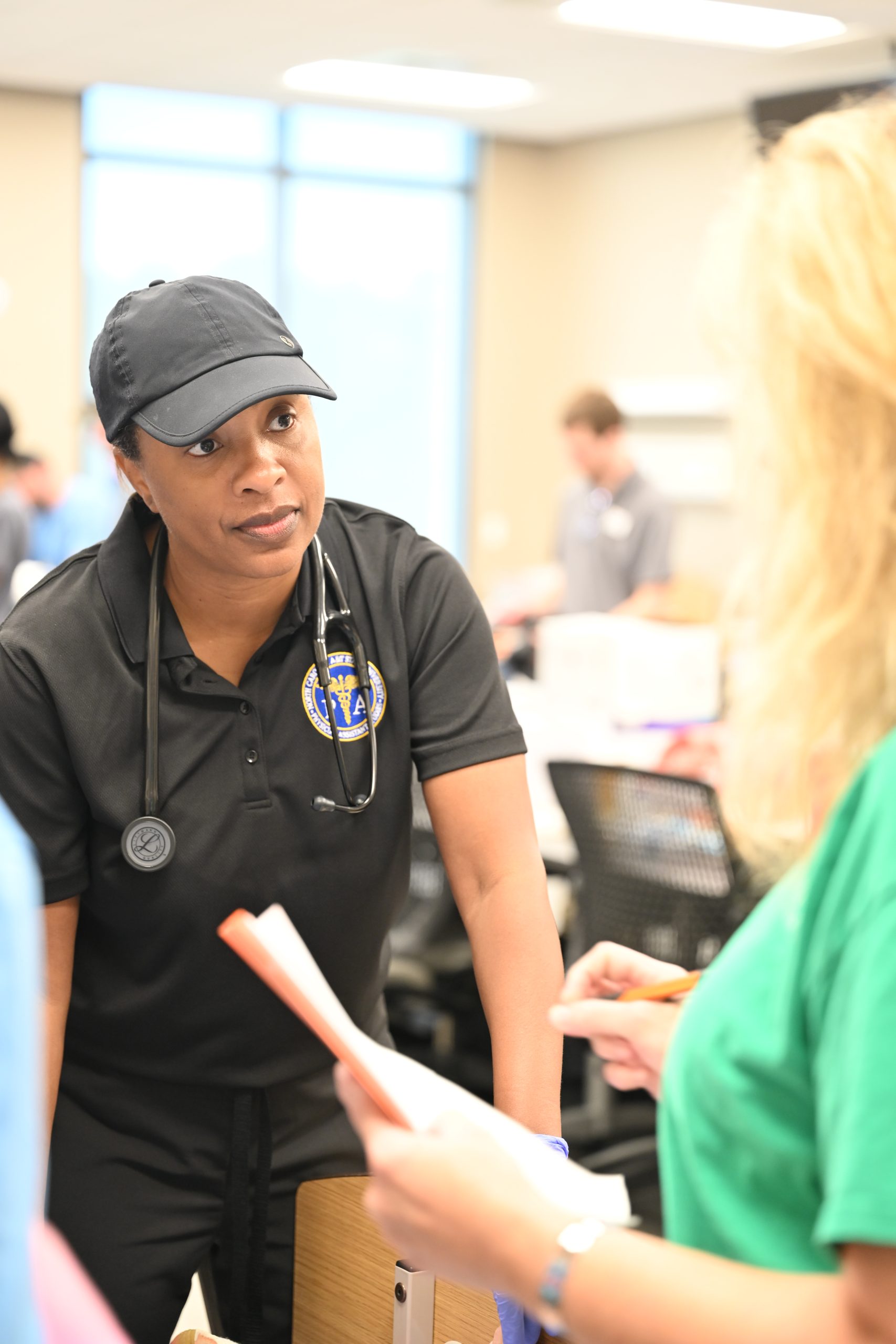 Female PA student from NC A&T listens to a female nursing professor about treating an emergency injury