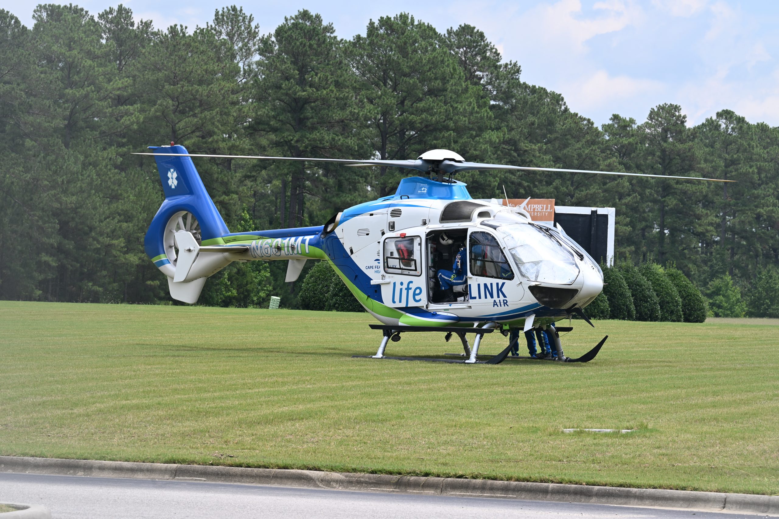 LifeLink helicopter sitting on lawn on the Health Sciences campus