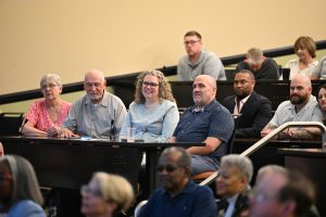 Audience members watch a presentation during a recognition ceremony at the Campbell University College of Pharmacy & Health Sciences.