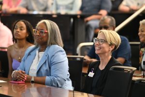 Attendees smile and listen during a recognition ceremony at the Campbell University College of Pharmacy & Health Sciences.