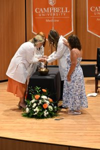 Blessing a students' hands on stage