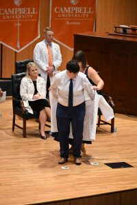 Student being coated on stage