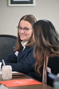 Student chatting with a student sitting beside her