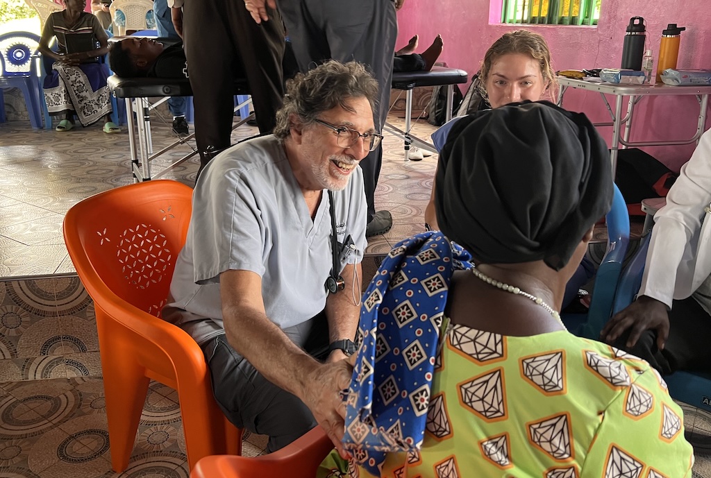Dr. Joe Cacioppo speaking with people in Kenya
