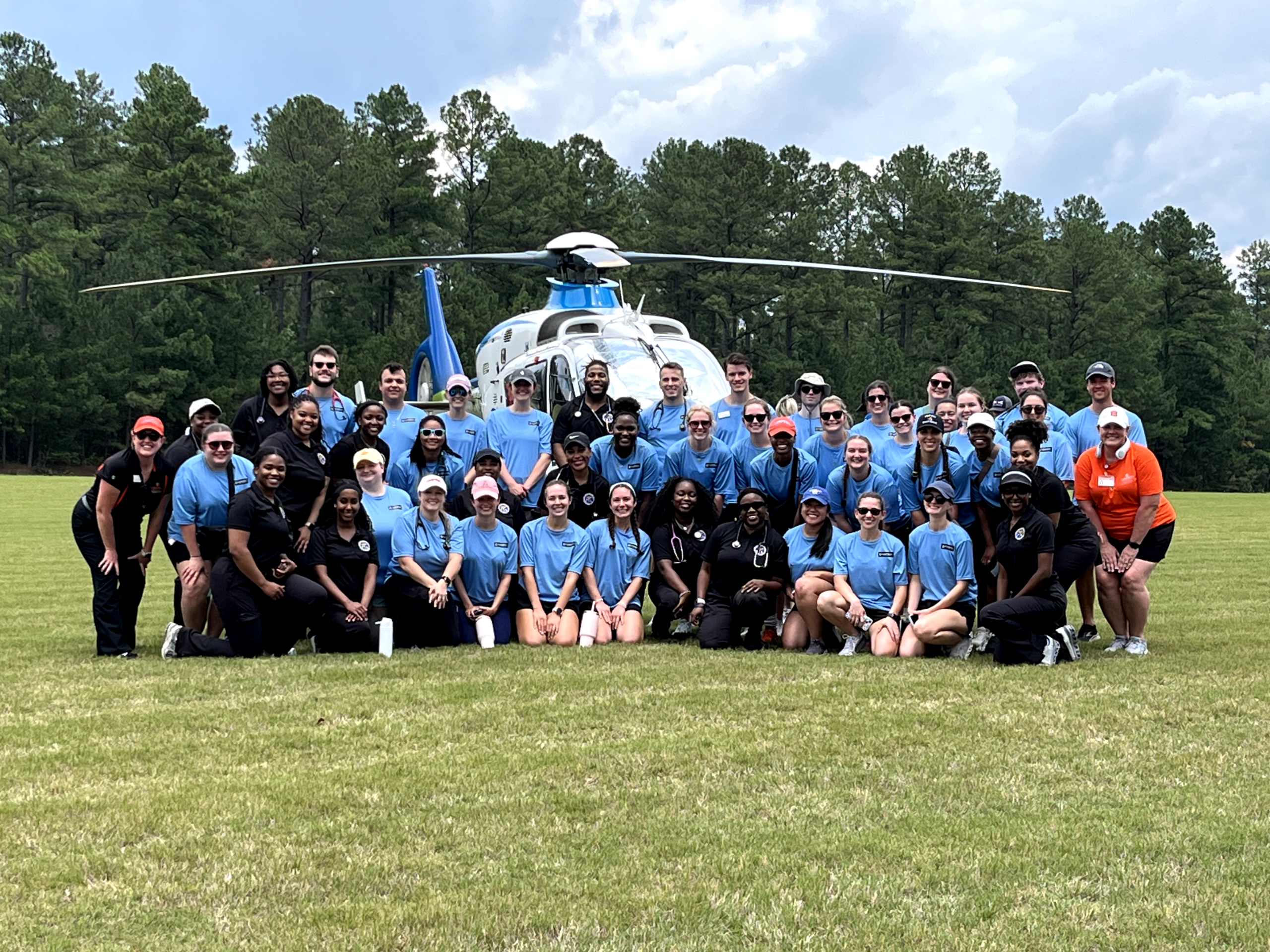 Full group of all PA students and PA fauculy with helicopter