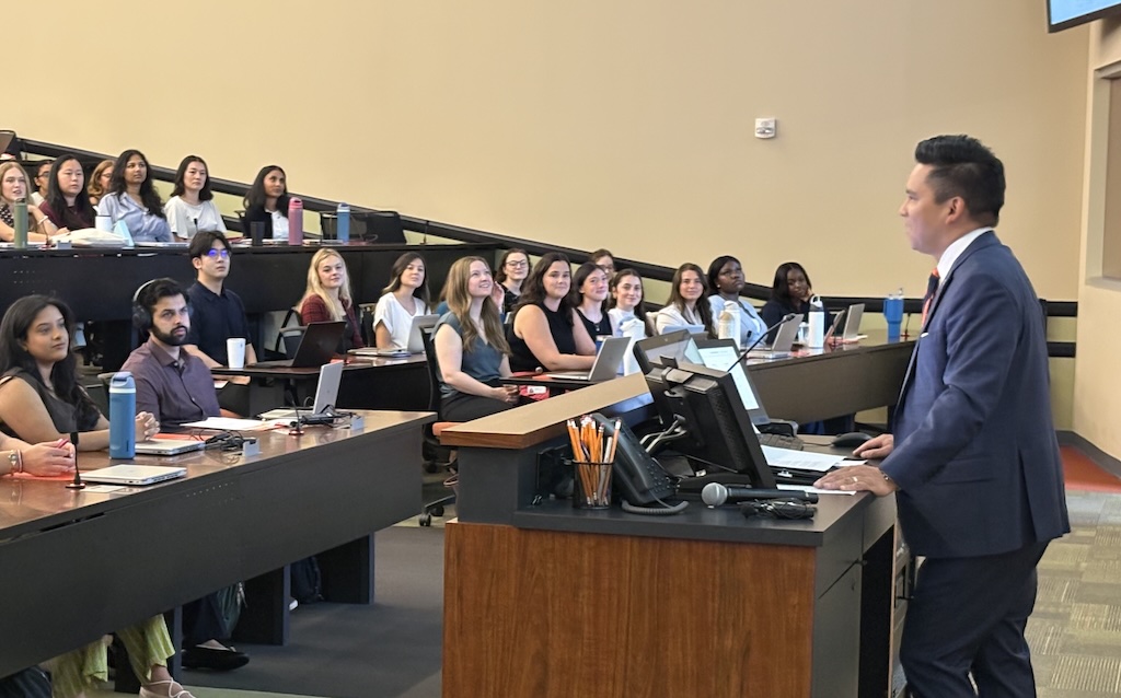Dr. Tolentino talks to new students at CUSOM orientation,