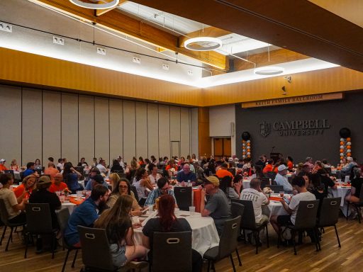 A large group of Campbell University legacy students and family members gather around tables in the Keith Family Ballroom during the annual Legacy Luncheon.