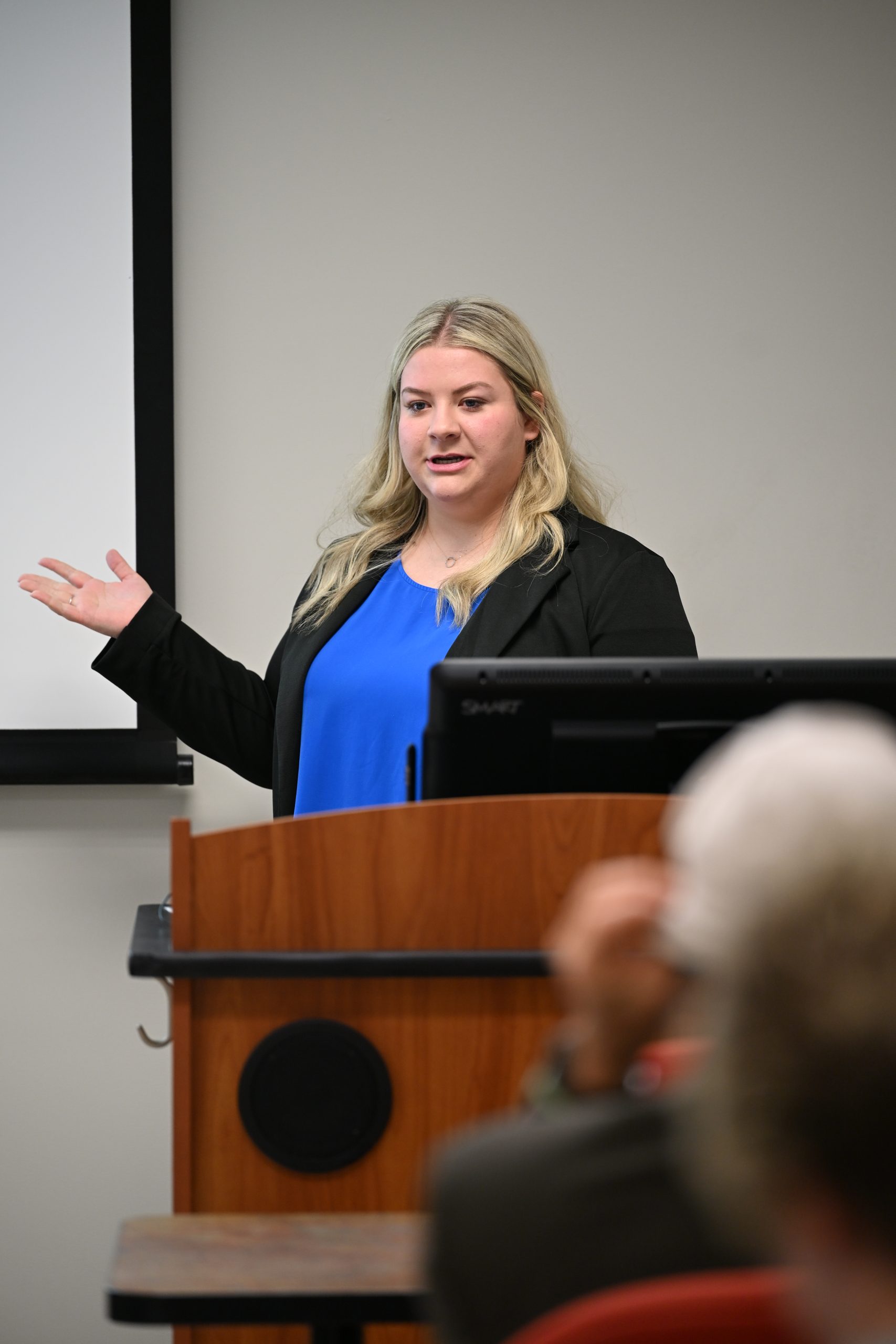 student presenting at podium