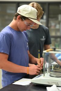 Student building a spaghetti tower