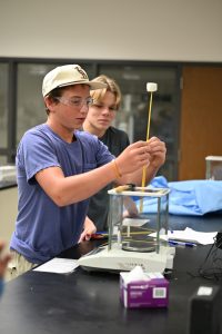 Student tapping a spaghetti tower