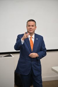 President Downs points to a student in the classroom
