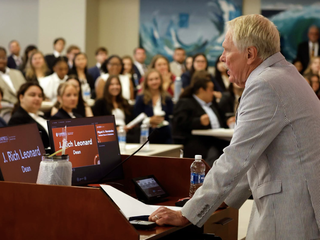 Photo of Dean J. Rich Leonard speaking to a roomful of incoming students