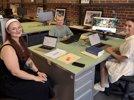 Photo of three Campbell Law students sitting at desks in the Blanchard Community Law Clinic