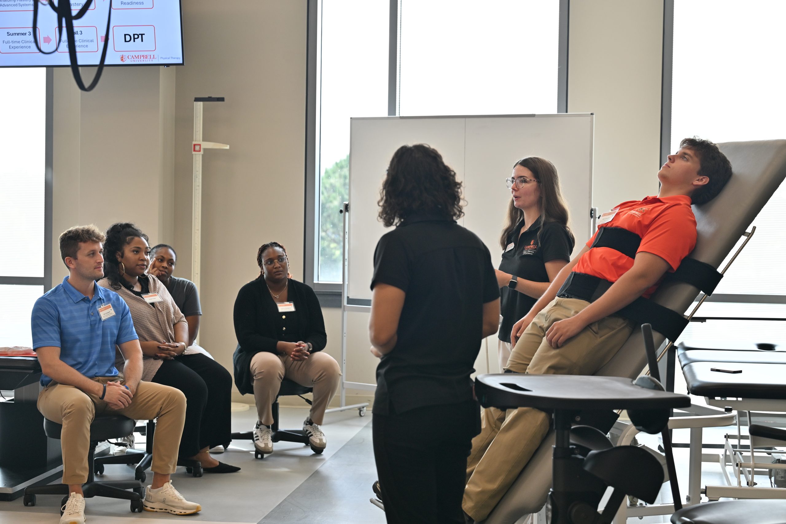 Student strapped onto movable table  for demonstration
